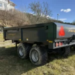 Grå dumpervagn 8 ton parkerad utomhus på gräsmatta